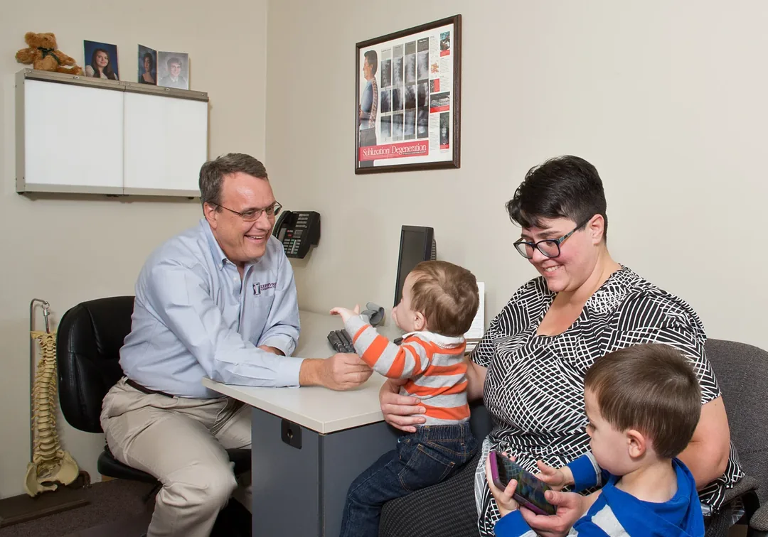 Dr. James T. Lefebvre speaking with a family in our office